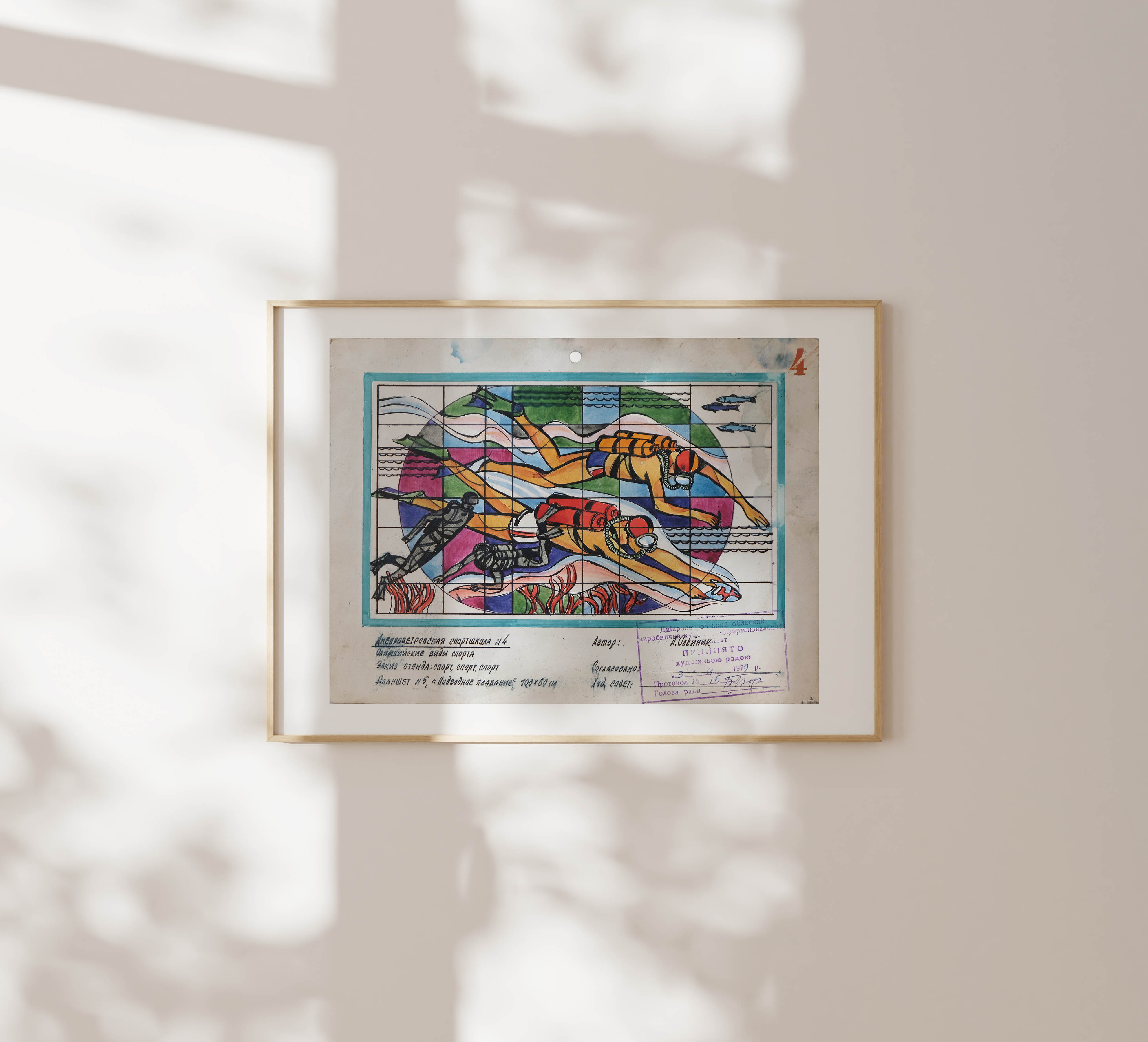 A framed graphic illustration of scuba divers hanging on a minimalist neutral wall, illuminated by soft window shadows.