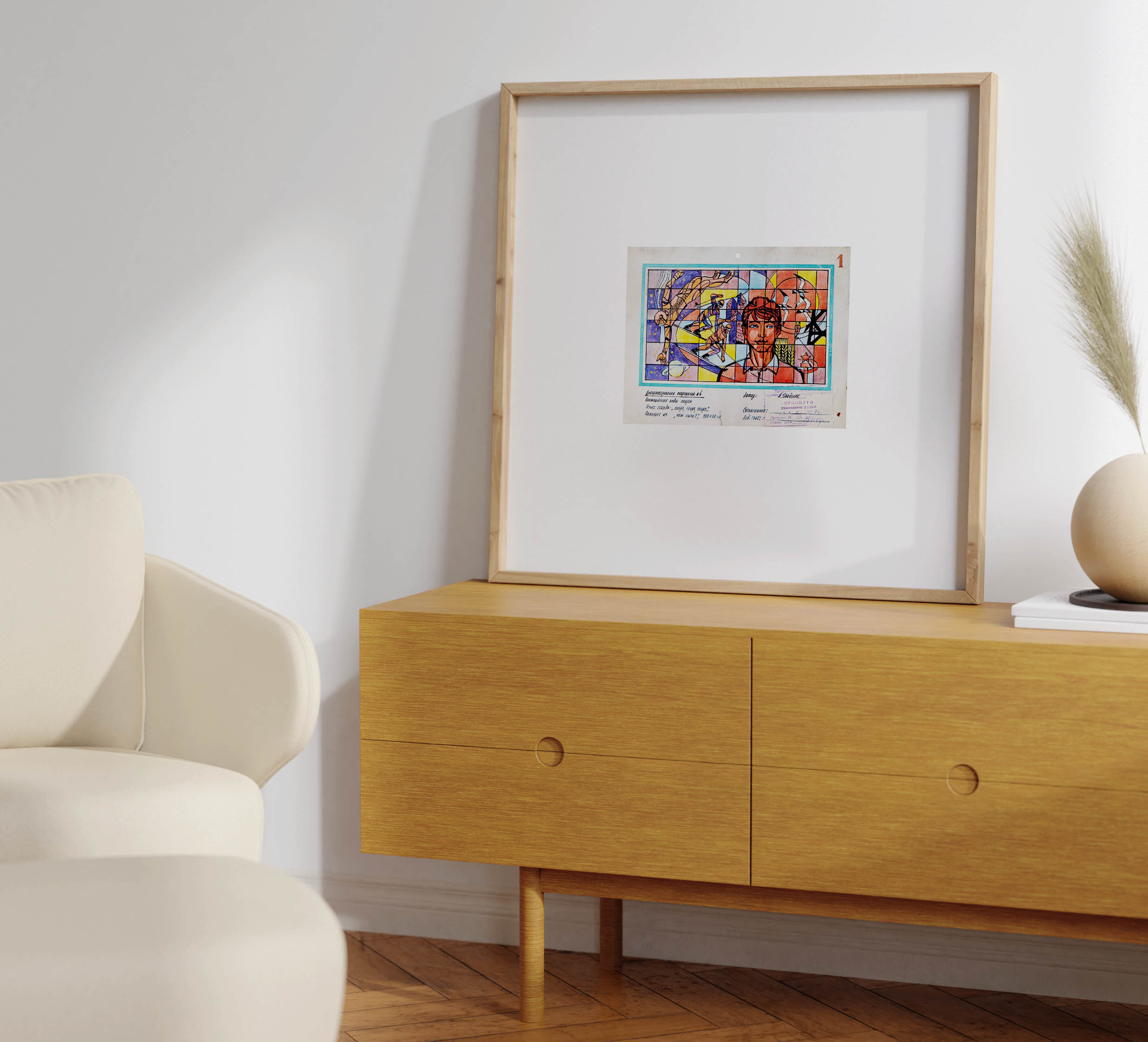 Living room interior with a light-coloured wooden sideboard and cream armchair, showcasing the framed Soviet sports design sketch resting on the sideboard next to a rounded vase with dried grass.